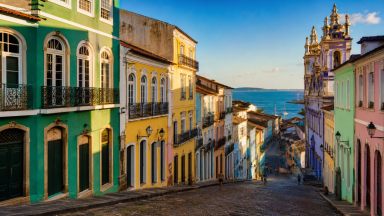 Historic center street in Bahia with colorful colonial houses and ocean view