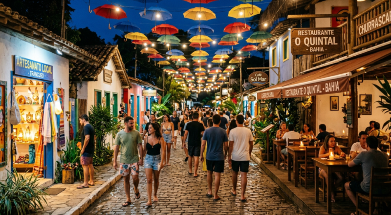 Colorful umbrellas suspended over a lively pedestrian street in Vila de Porto de Galinhas