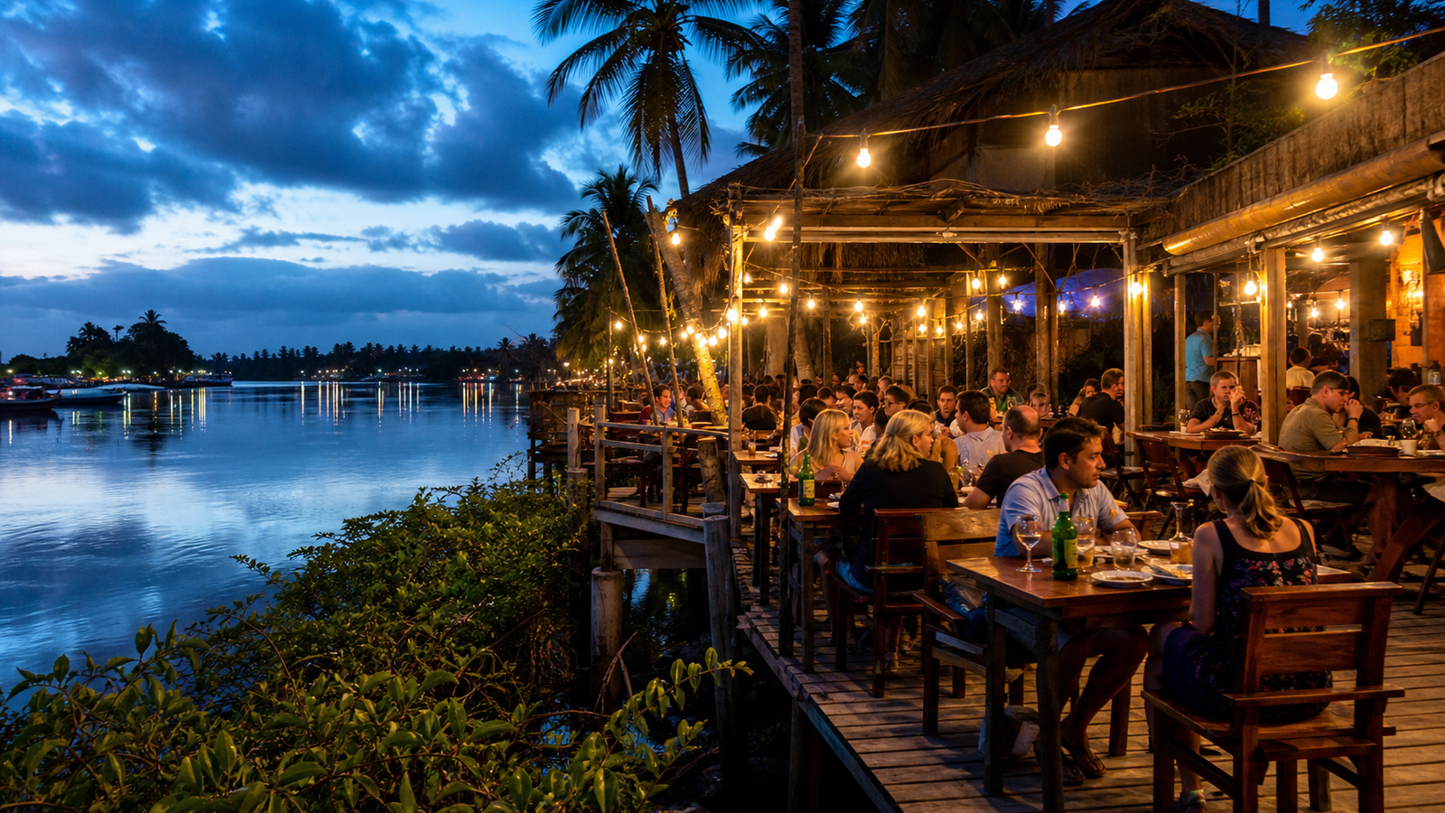 Open-air waterfront restaurants along Avenida Beira-Rio in Barreirinhas at dusk