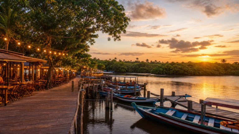 Exploring Barreirinhas: A Walkable Guide to the Gateway of Lençóis Maranhenses 3 Avenida Beira-Rio waterfront promenade in Barreirinhas at sunset with wooden piers and boats along the Rio Preguiças