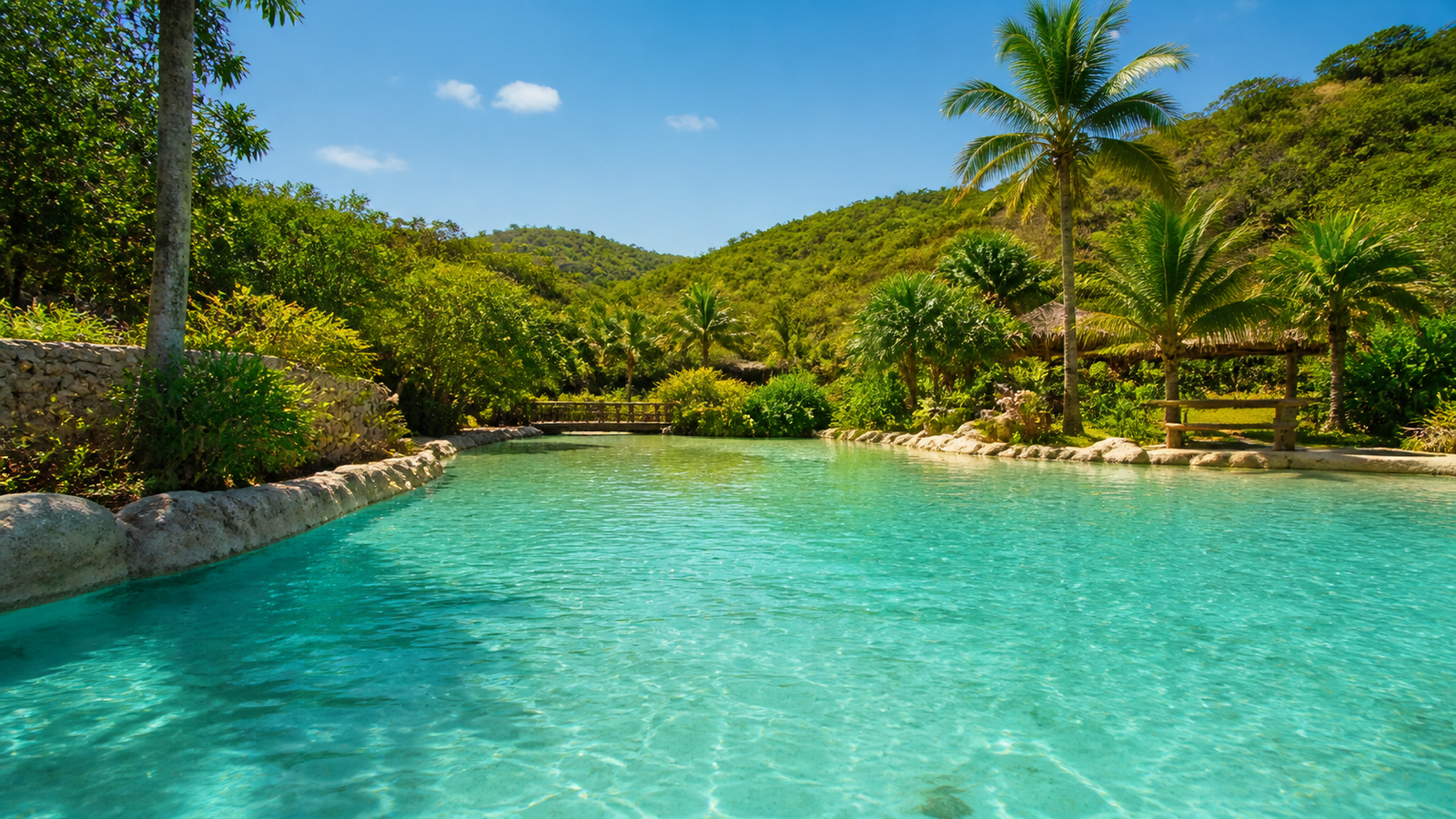 Naturally heated thermal turquoise pool surrounded by tropical Cerrado palms under sunny skies in Caldas Novas Goiás