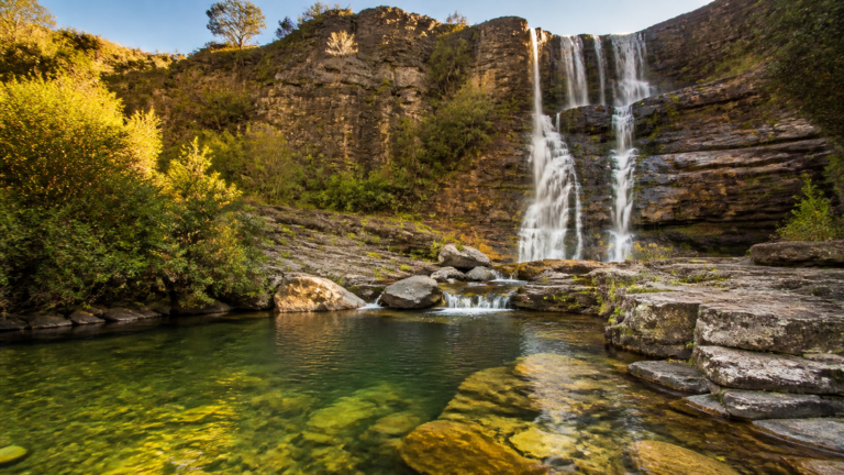 Majestic quartzite canyon cliffs and cascading waterfall in Chapada dos Veadeiros, Brazil
