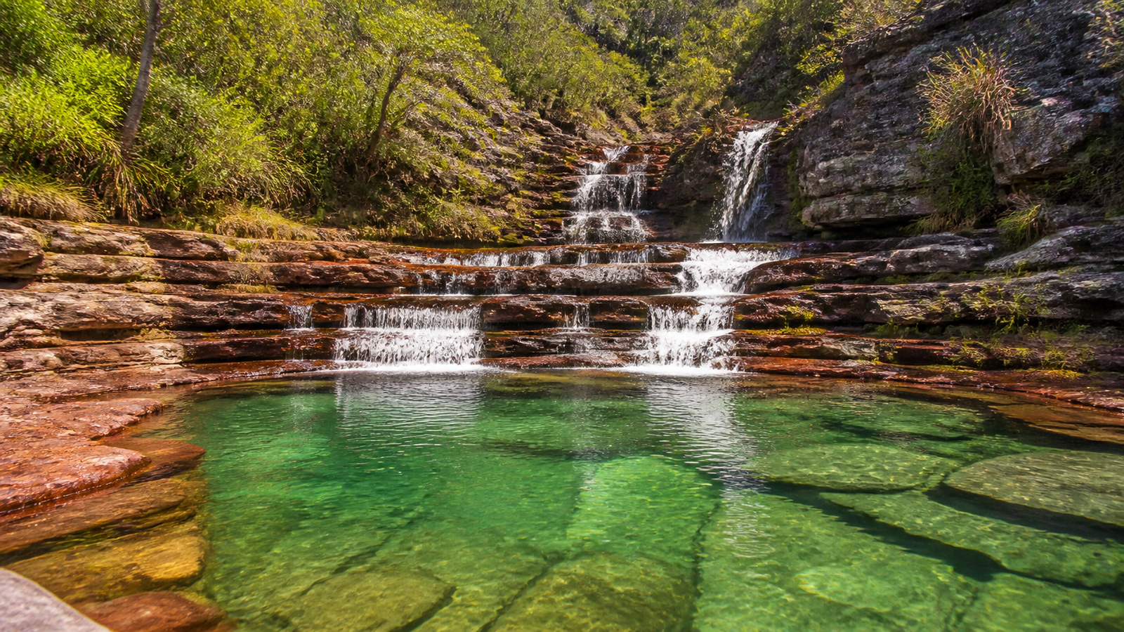 Multi-tiered cascade and emerald swimming pools in Complexo Macaquinhos, Chapada dos Veadeiros.