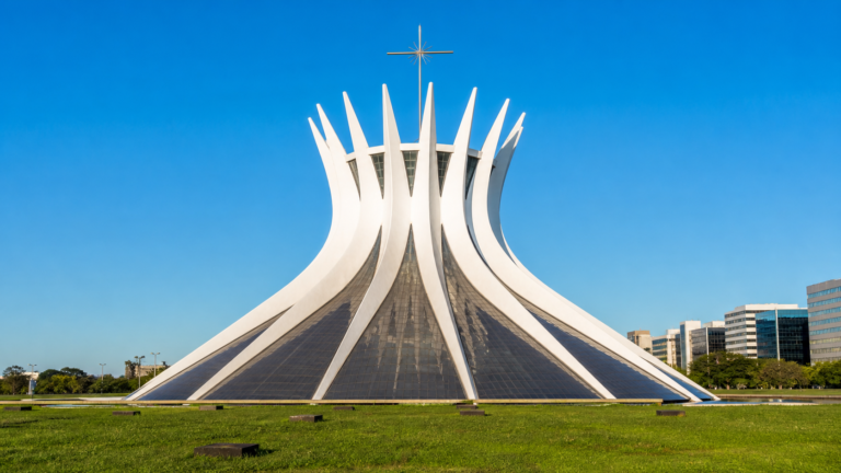 Cathedral of Brasília with its white curving concrete columns under a clear blue sky on the Monumental Axis