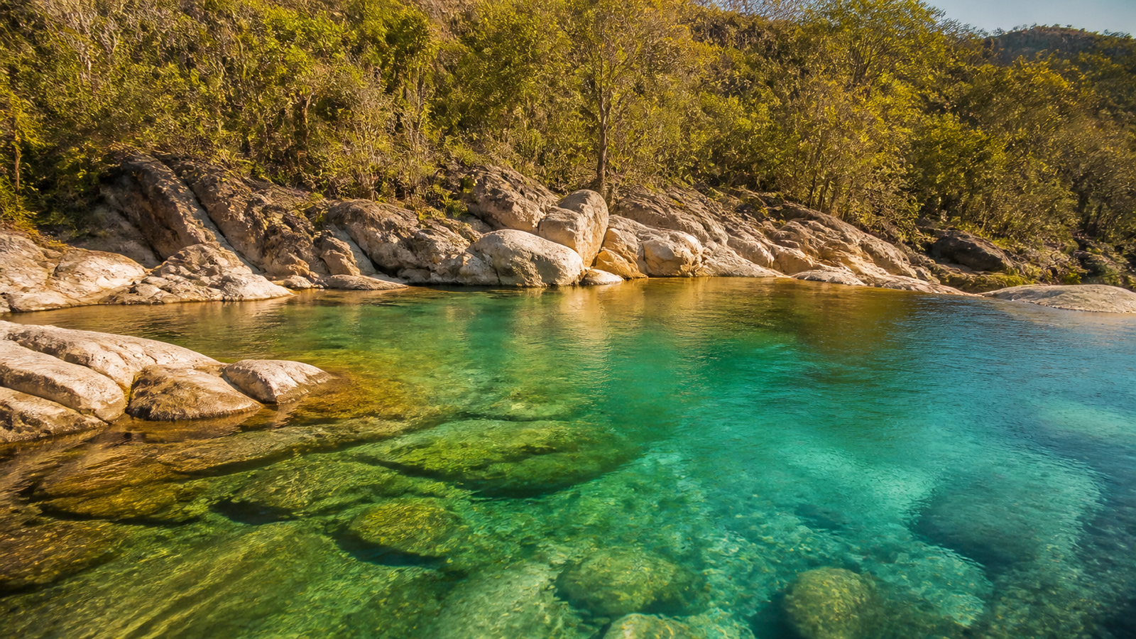 Crystal clear turquoise water at Poço das Esmeraldas in Fazenda Volta da Serra, Chapada dos Veadeiros.