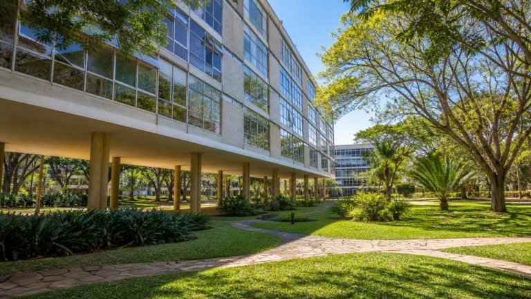 Modernist residential buildings on pilotis surrounded by lush tropical gardens in SQS 308, Brasília