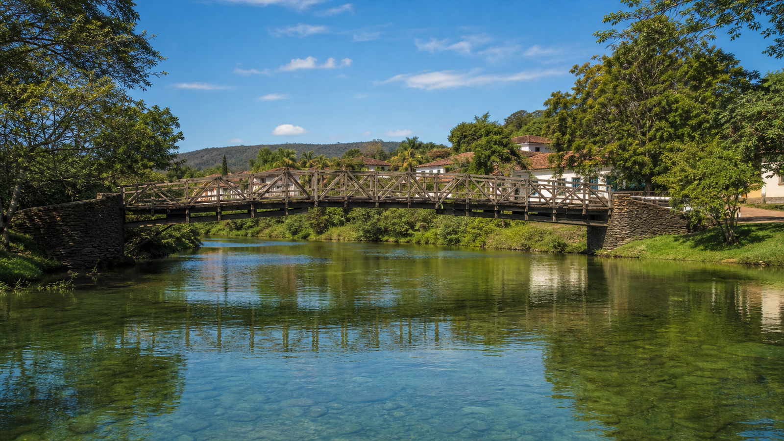 Historic wooden bridge Ponte Velha spanning the green Rio das Almas river in Pirenópolis