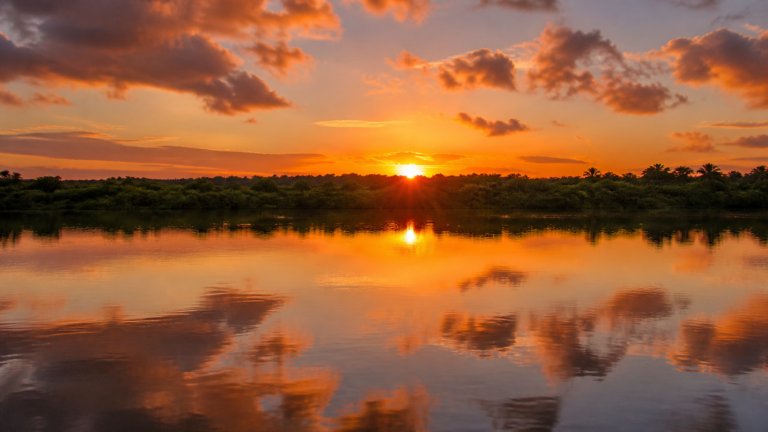 Sunset over the calm waters of the Paraíba River estuary at Praia do Jacaré in Cabedelo near João Pessoa