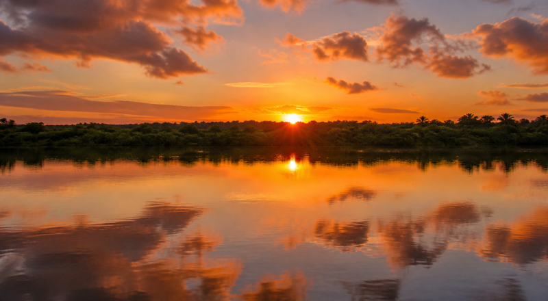 Sunset over the calm waters of the Paraíba River estuary at Praia do Jacaré in Cabedelo near João Pessoa