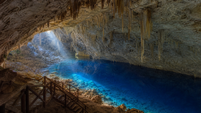 View inside Gruta do Lago Azul in Bonito Brazil showing the vast limestone cavern and sapphire subterranean lake