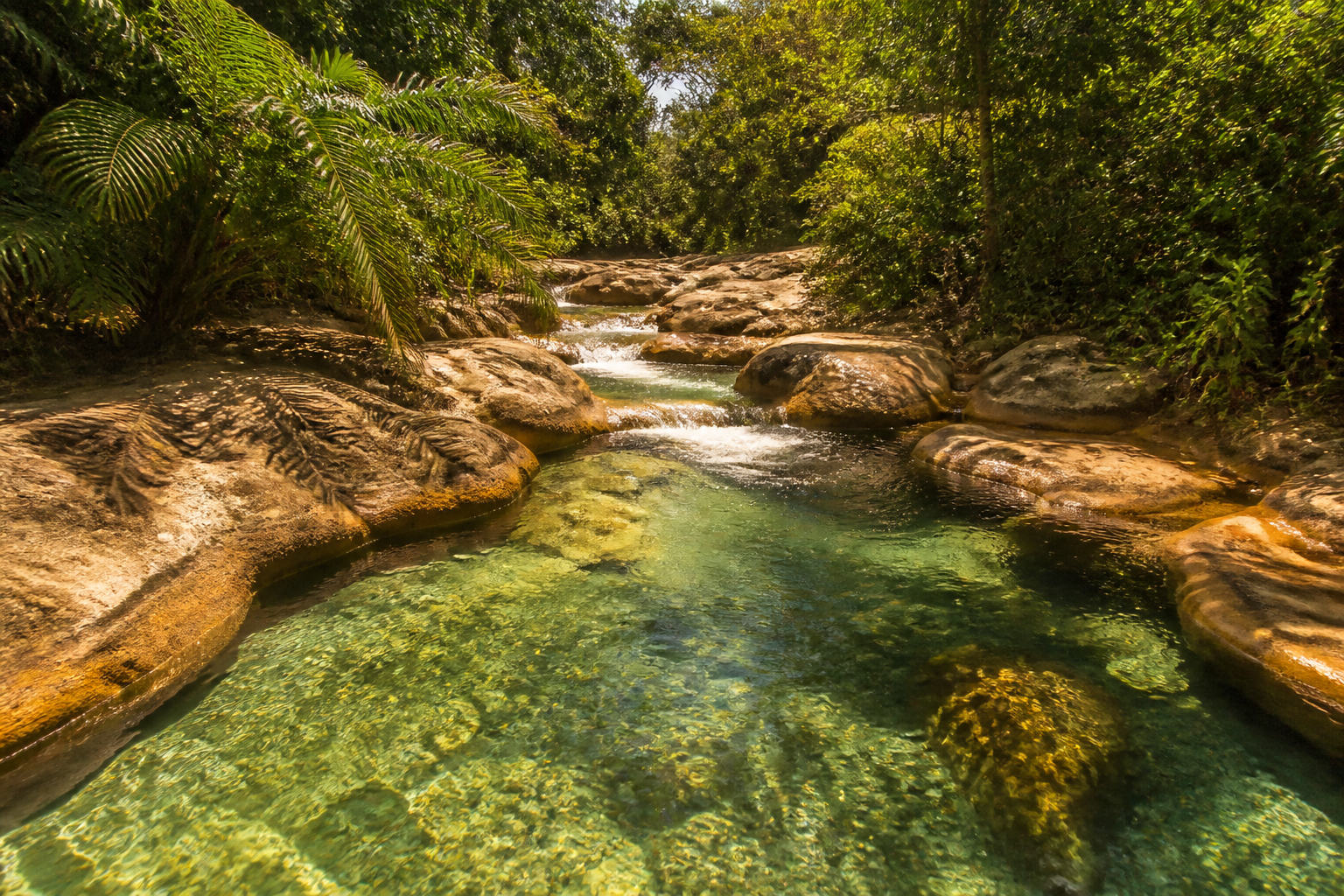 Natural warm thermal river flowing through resort rock pools in Rio Quente Brazil