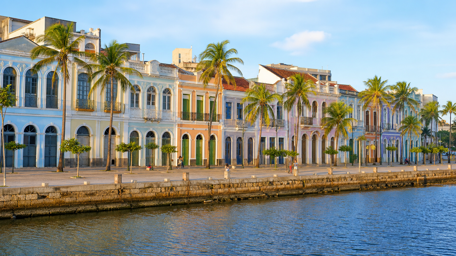 Colorful pastel neoclassical row houses along Rua da Aurora waterfront promenade in Recife.